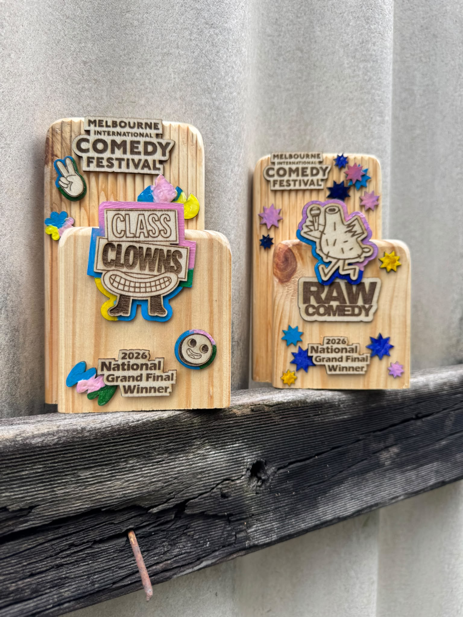 Two Melbourne International Comedy Festival trophies in solid reclaimed timber.
