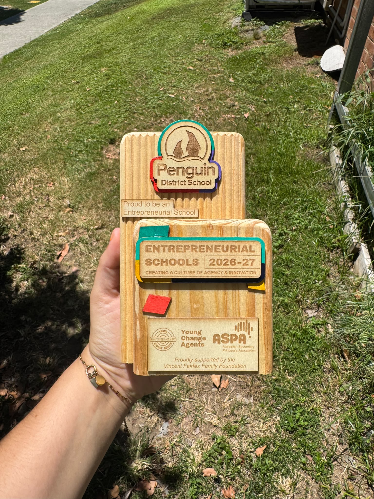 An engraved reclaimed-timber Entrepreneurial Schools plaque for Penguin District School.