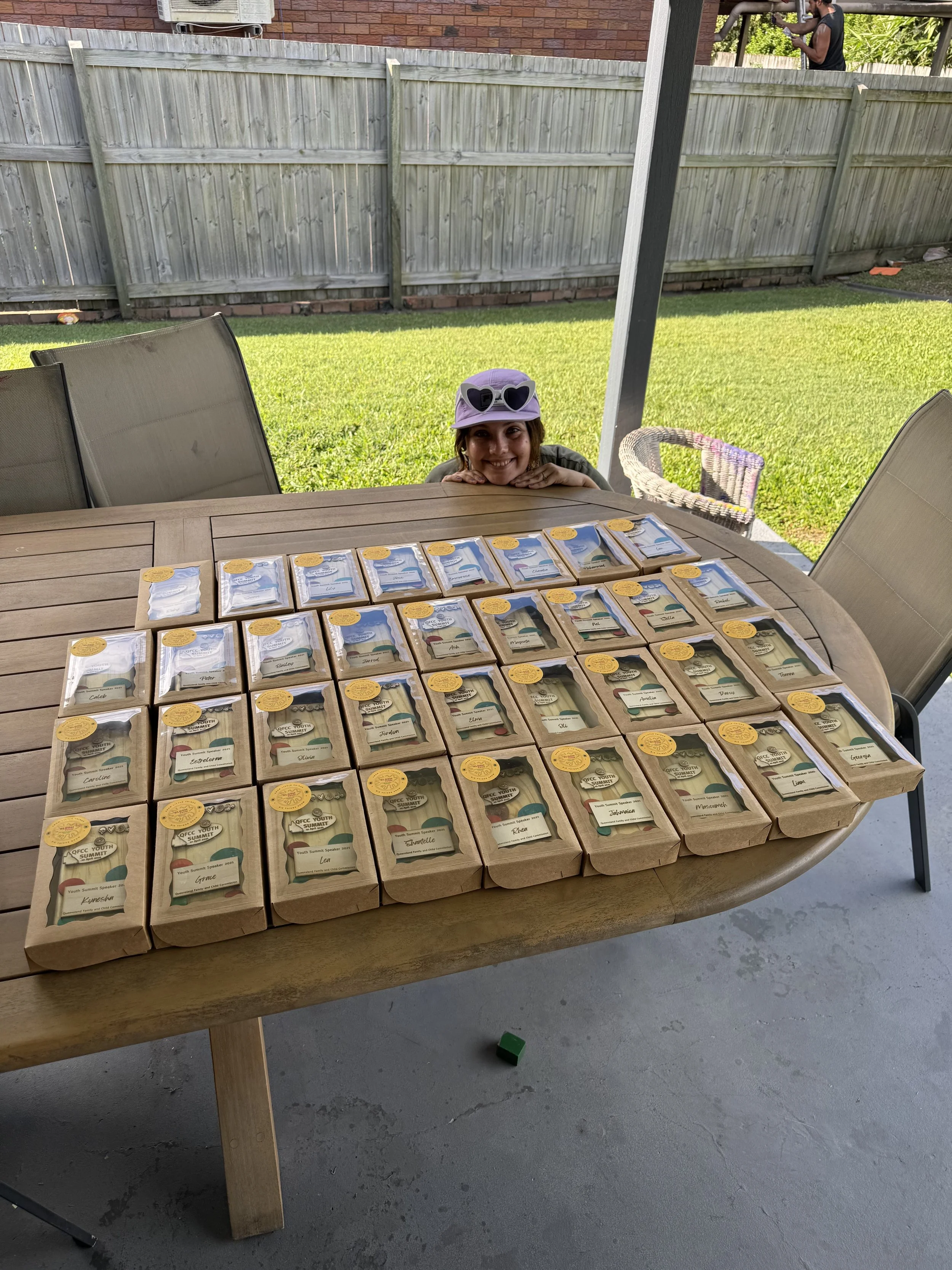 Dozens of individually wrapped Bloom Cycle trophies laid out on a table, ready to ship.